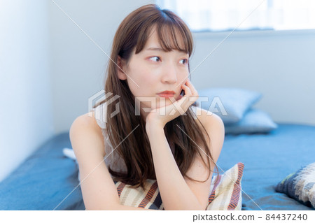 A woman wearing a cheek stick with an anxious expression A woman wearing a cheek stick with an anxious expression 84437240