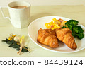 One plate of croissant and mug with cafe au lait 84439124
