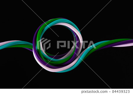 Swirl of telecommunication electrical cable wire isolated on black background 84439323