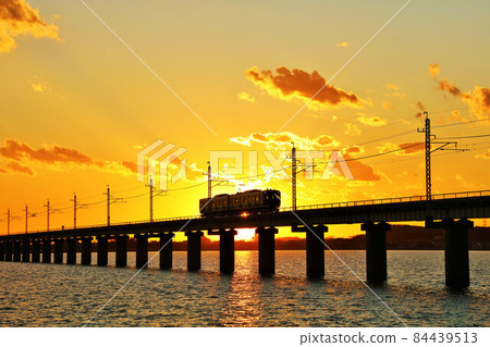 Ibaraki Prefecture, Kitaura Bridge and train at dusk 84439513