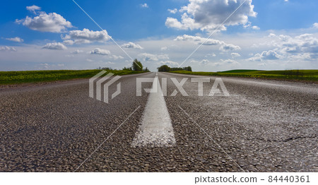 Low angle view of a tarred road receding Low angle view of a tarred road receding 84440361