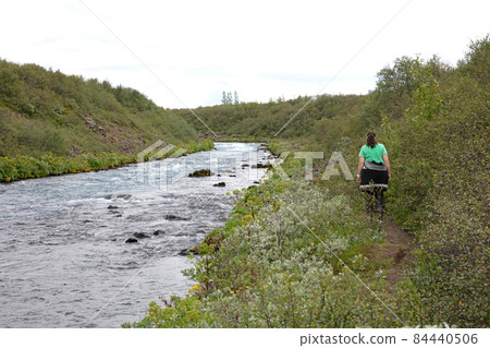 Woman in traditional Icelandic sweater enjoying the Icelandic landscape Woman in traditional Icelandic sweater enjoying the Icelandic landscape 84440506
