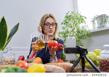Woman nutritionist recording a video about healthy food, nutrition Woman nutritionist recording a video about healthy food, nutrition 84440616