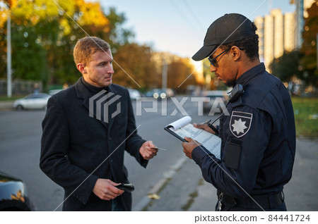 Police checking the driver's license from driver Police checking the driver's license from driver 84441724