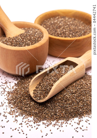 Wooden scoop of organic natural chia seeds close-up isolated on white background 84442741