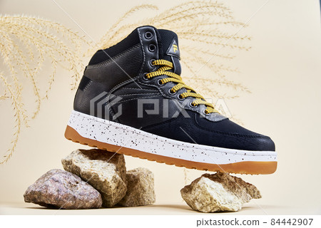 Male winter shoes on beige background Male winter shoes on beige background 84442907