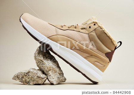 Male winter shoes on beige background Male winter shoes on beige background 84442908