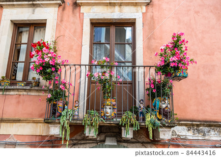 Typical Sicilian balcony in Taormina full of flowers and decorations Typical Sicilian balcony in Taormina full of flowers and decorations 84443416