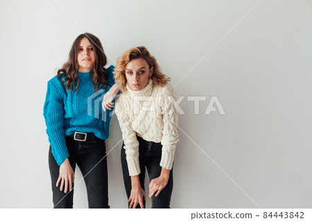two beautiful fashionable women friends hugging nice 84443842