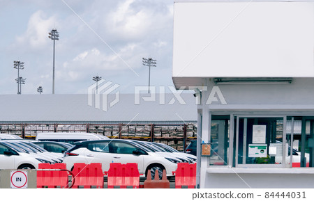 New cars stock at parking lot of car factory. Car production manufacturing. Car stock waiting for sale. Car factory parking lot and guardhouse for security. Automotive Industry. Automobile business. 84444031