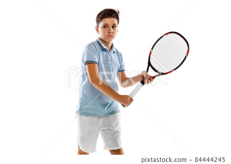 Cropped portrait of boy, professional tennis player in uniform with racket posing isolated over white background Cropped portrait of boy, professional tennis player in uniform with racket posing isolated over white background 84444245