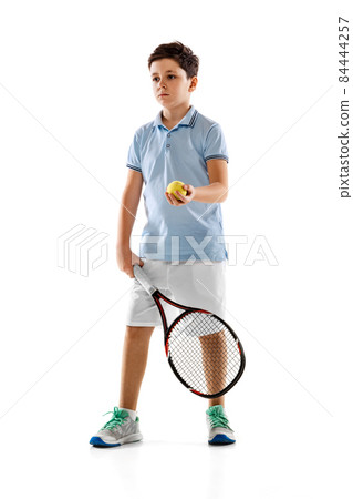 Full-length portrait of boy, playing tennis, training isolated over white background. Sportive youth Full-length portrait of boy, playing tennis, training isolated over white background. Sportive youth 84444257