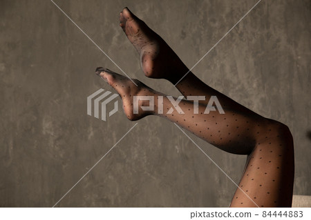 beautiful women's slender legs in black tights 84444883