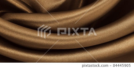 Smooth elegant brown silk or satin texture as abstract background. Luxurious background design. In Sepia toned. Retro style Smooth elegant brown silk or satin texture as abstract background. Luxurious background design. In Sepia toned. Retro style 84445905