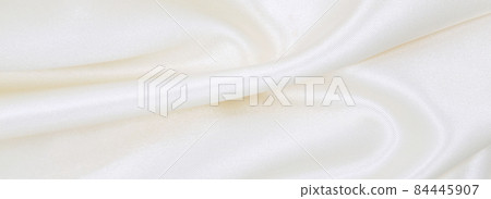Smooth elegant white silk or satin luxury cloth texture as wedding background. Luxurious background design Smooth elegant white silk or satin luxury cloth texture as wedding background. Luxurious background design 84445907