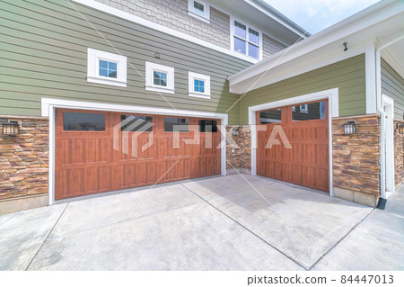 Craftsman style three-car garage parking exterior of a house 84447013