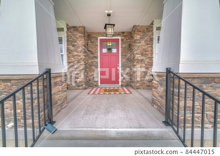 Exterior of a front entrance of a house with stone walls 84447015