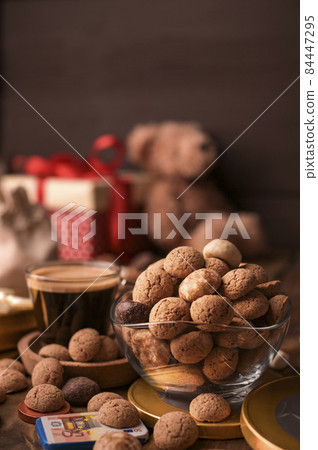 Dutch holiday Sinterklaas. kruidnoten cookies sweets, chocolate and a gift for the child. Children 84447295