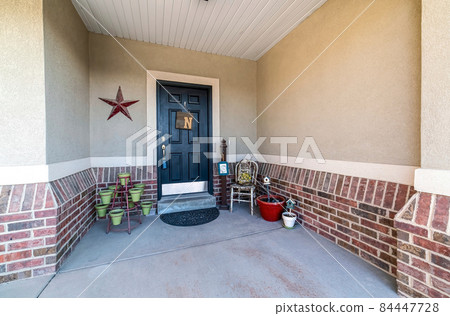 Front door exterior with decorative displays and pots Front door exterior with decorative displays and pots 84447728