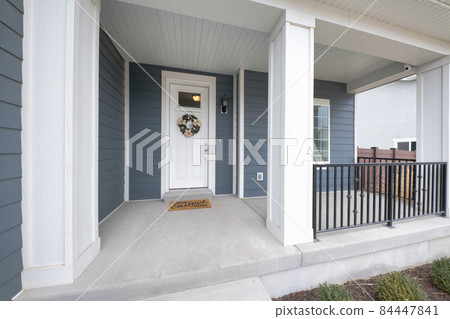 Exterior of a front porch of a house with gray and white tones 84447841