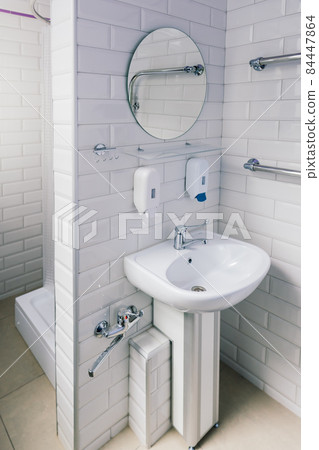 View of a new toilet and bathroom interior for hospital, white and clean 84447864