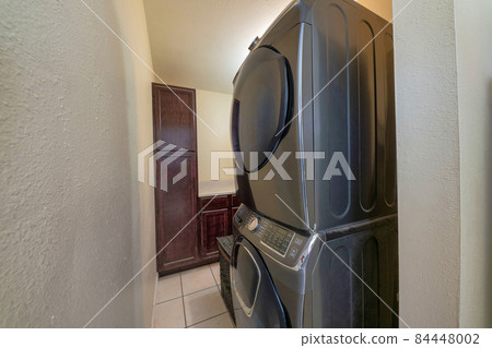 Small space laundry room interior with narrow passages 84448002