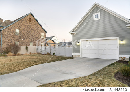 Detached garage with closed white door and gable design exterior 84448310
