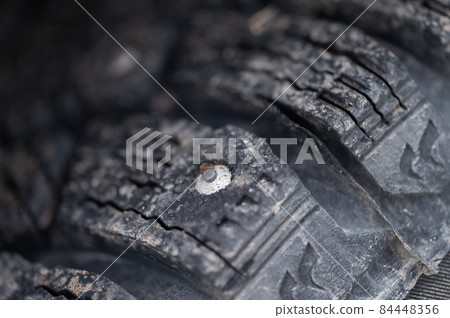 Close-up of winter studded wheels. Macro. 84448356