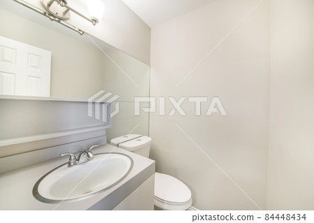 White bathroom interior with large wall mirror and built in shelf 84448434