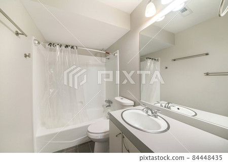 Interior of a small bathroom with gray and white tones Interior of a small bathroom with gray and white tones 84448435