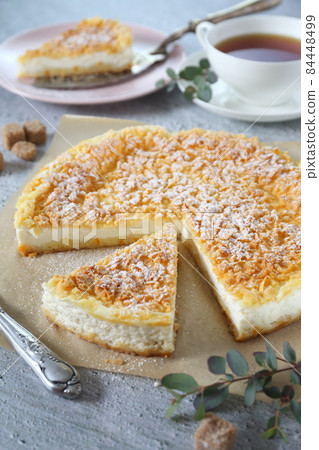 Italian ricotta (cottage cheese) grated tart and cup of tea 84448499