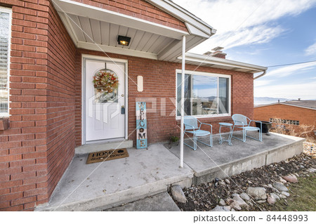 Exterior of an elevated house with bricks and decorative displays Exterior of an elevated house with bricks and decorative displays 84448993