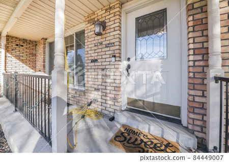 Front door with ornate glass panel and a home sweet home doormat Front door with ornate glass panel and a home sweet home doormat 84449007