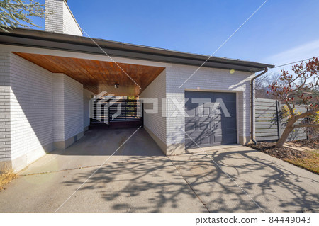 Exterior of a garage with a wooden ceiling and the sun shines. Exterior of a garage with a wooden ceiling and the sun shines. 84449043