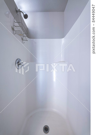 Shower area with a knob and rack under the shower head. Shower area with a knob and rack under the shower head. 84449047