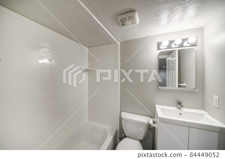 Small all white bathroom interior with vanity sink and mirror 84449052
