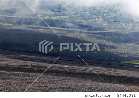 攀登富士山/御殿場山徑和雲霧繚繞的山坡的登山者 84449081