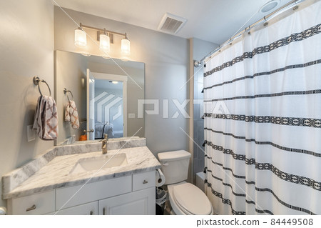 Small bathroom inside a room with ambient lightnings and bathtub Small bathroom inside a room with ambient lightnings and bathtub 84449508