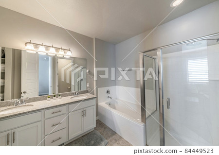 Large master bathroom with ambient lights and separated toilet 84449523