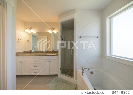 Master bathroom with corner shower stall and window Master bathroom with corner shower stall and window 84449562