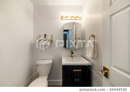 Modern powder room design with matching gold fixtures 84449598