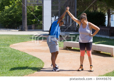 Plus size women doing sports on sunny day 84449870