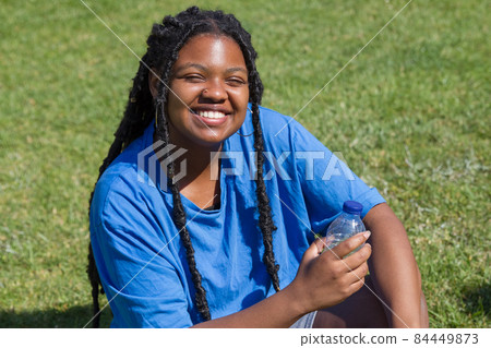 Smiley African-American woman resting after training Smiley African-American woman resting after training 84449873