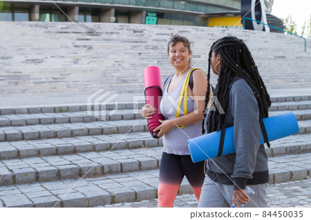 Smiling plus size women going home after training 84450035