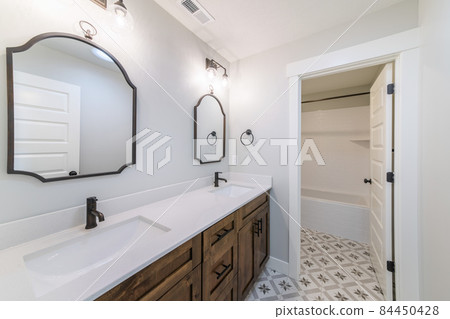 Bathroom interior with vanity sink and separate bathtub 84450428