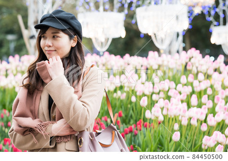 Female enjoying winter tulips 84450500