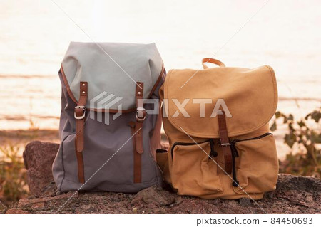 couple backpacks rocks sunset. High quality photo 84450693