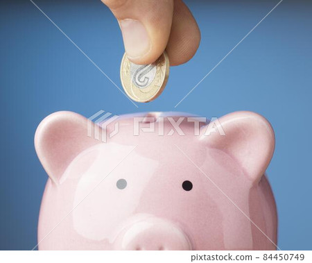 person placing coin piggy bank. High quality photo 84450749