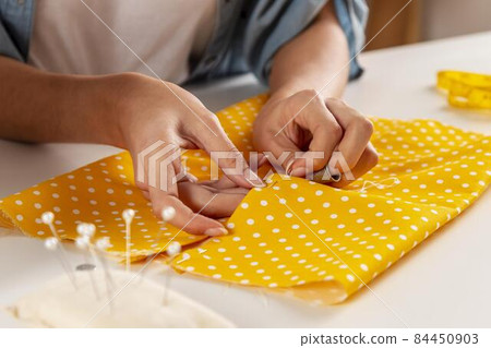 hands sewing fabric. High quality photo hands sewing fabric. High quality photo 84450903