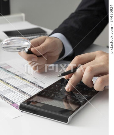 business man calculating finance numbers. High quality photo business man calculating finance numbers. High quality photo 84450924